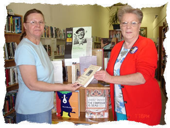 Librarian Carol Lee tells Patron Vickie Huff about "The Big Read"